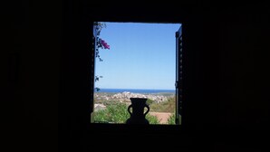 A window with a view of a town and the sea. - Vacation home with sea view, Budoni - Sardinia  (Solitá)