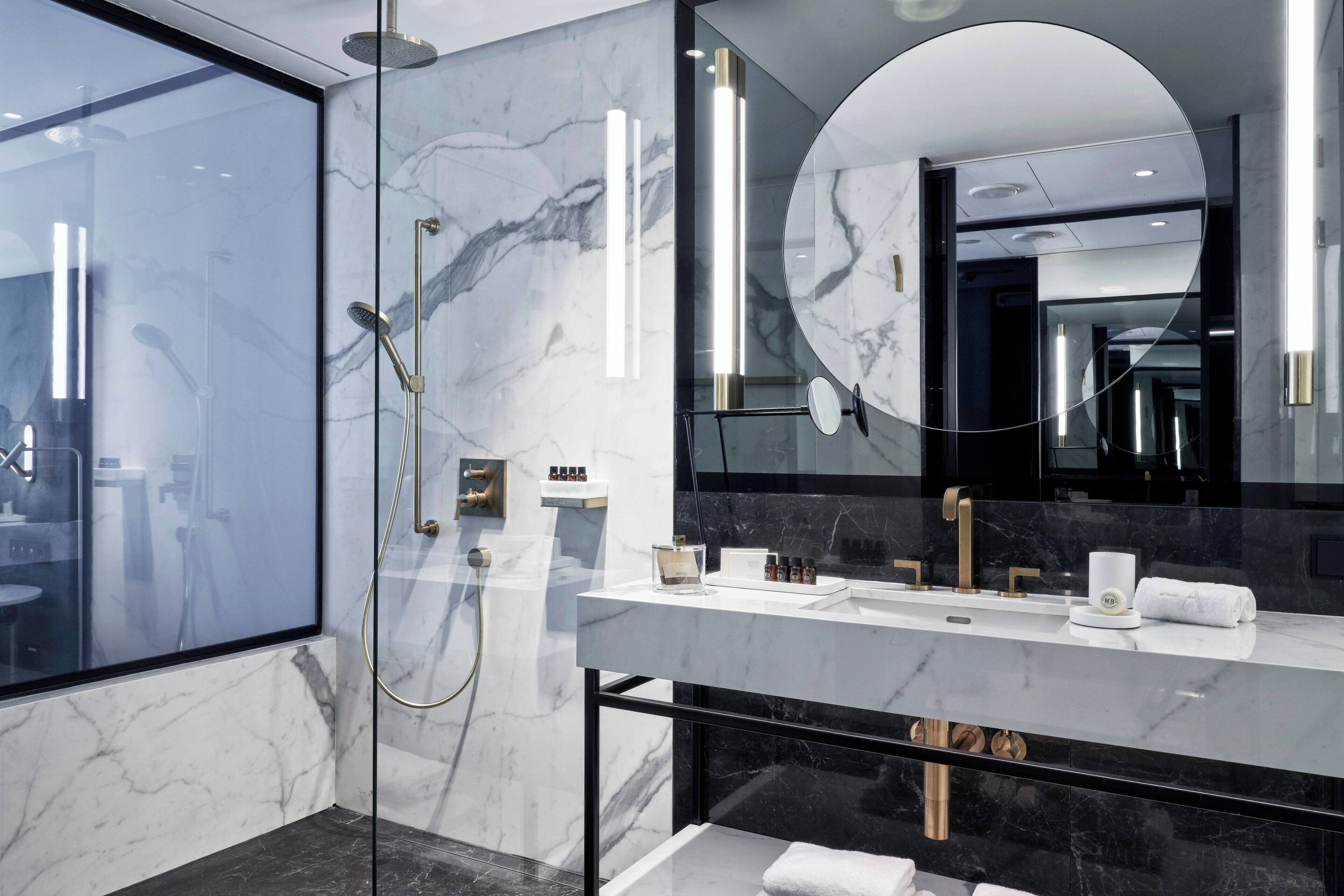 designer toiletries, hair dryer, bathrobes, slippers