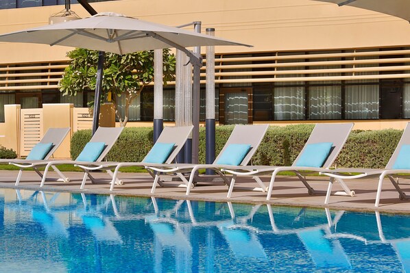 Outdoor pool, open 6:00 AM to 6:00 PM, pool umbrellas, pool loungers