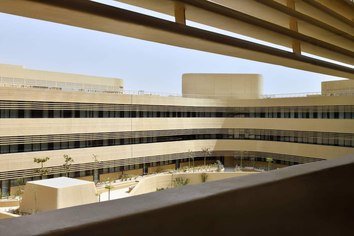 A multi-level building with a modern architectural design, featuring a series of terraces and a central courtyard.