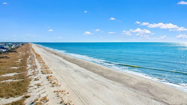 A beach with a sandy shore and a clear blue sky. - "Beach Time"  Oceanfront 3 bedroom 3 bath duplex (Holden Beach)