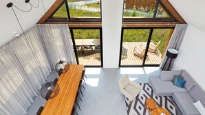 A modern interior with a wooden dining table, a sofa, and a patterned rug. - Eagle 8p - Four Bedroom Villa, Sleeps 8 (Oosterhout)