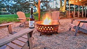 A fire pit with a bottle of beer on a wooden table, surrounded by Adirondack chairs. - 3 Mi to Golf & Wineries: Arroyo Grande Home! (Arroyo Grande)