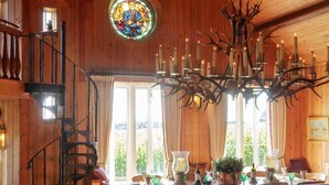A wooden interior with a dining area, staircase, and a chandelier. - 4 bedroom stunning rural position near Jurassic coast ! (Dorchester)