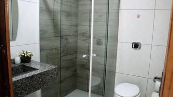 Shower, hair dryer, towels, toilet paper