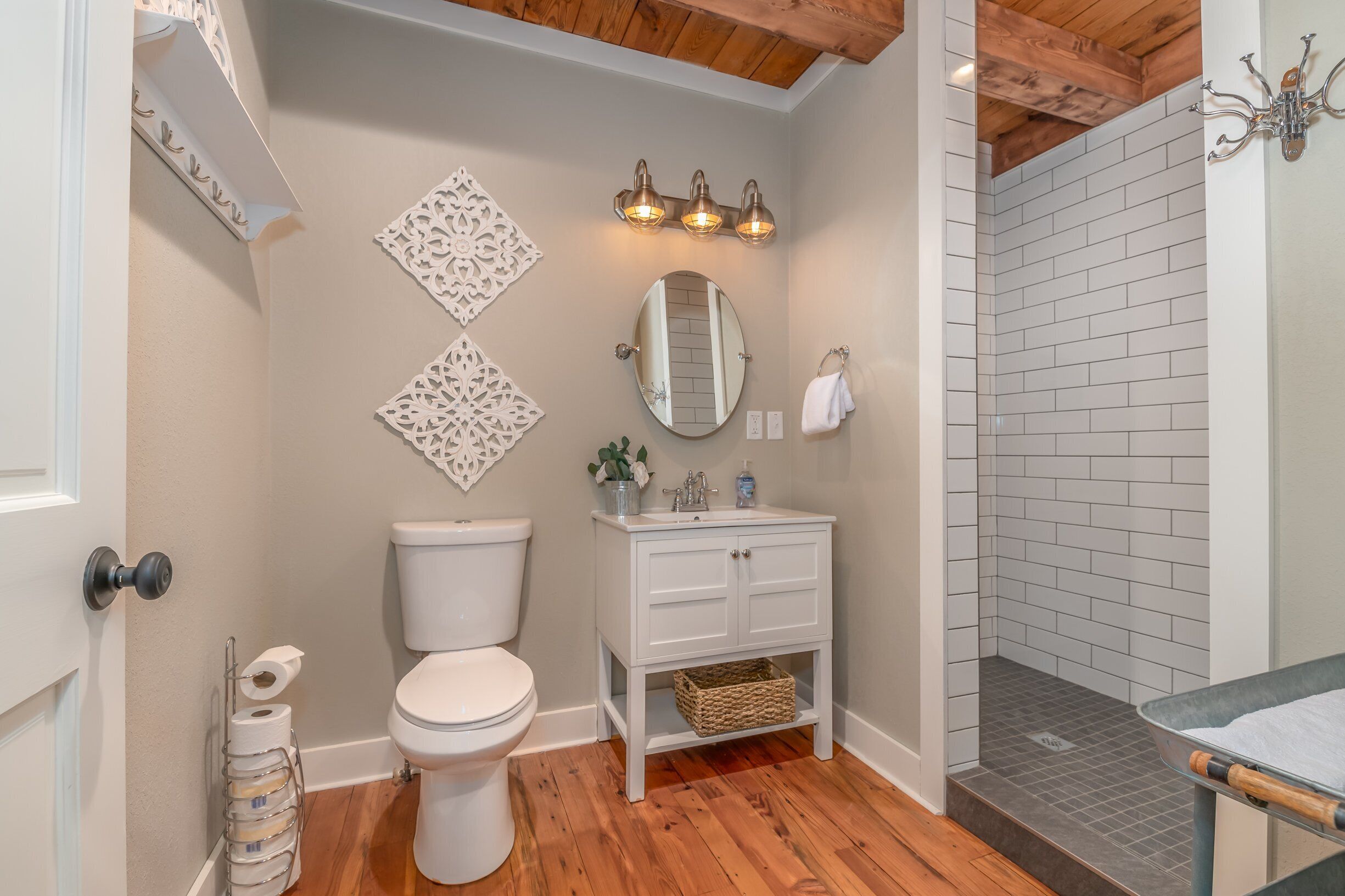 A bathroom with a toilet, sink, and shower area.