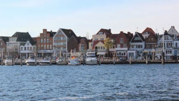 A waterfront with buildings and boats.