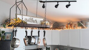 A kitchen with hanging pots, a coffee maker, and a sign that reads "Gittel". - Unique Farm Cottage, Close to City Feels like Country, One of a Kind! (Colorado Springs)