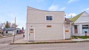 A two-story building with a flat roof, a small window, and a door. - 1BR Cozy Downtown Studio Condo: Hiking Nearby (Leadville)