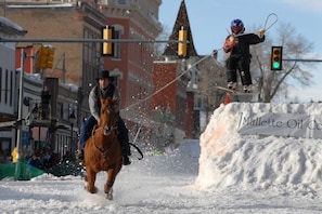 Horseback riding through the city streets in winter.