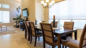 A dining area with a chandelier, a dining table, and chairs. - Very spacious, private location with open area, good for family travel (Sugar Land)
