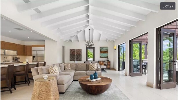 A spacious living room with a large sectional sofa, a coffee table, and a woven basket. - Villa Mango - Bahia Beach Resort, Luxury 4 bed / 4 bath Penthouse in St Regis Bahia Beach Resort (Herreras)
