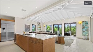 A spacious kitchen with a large island, wooden cabinets, and a modern ceiling design. - Villa Mango - Bahia Beach Resort, Luxury 4 bed / 4 bath Penthouse in St Regis Bahia Beach Resort (Herreras)