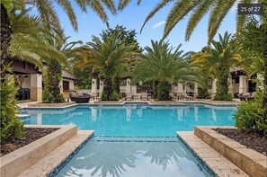 Relax by the serene pool surrounded by lush palm trees and beautifully maintained gardens.