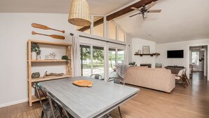 A spacious living area with a dining table, chairs, a sofa, and a TV. - Peaceful Lake Granbury Retreat - Private Dock (Granbury)