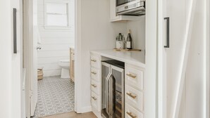 A modern kitchen with white cabinetry, a microwave, and a refrigerator. - Peaceful Lake Granbury Retreat - Private Dock (Granbury)