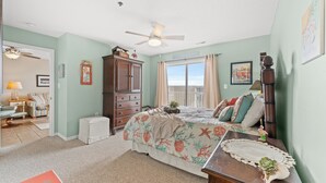 A bedroom with a bed, dresser, and a ceiling fan. - Spacious 2 Bedroom/2 bathroom Condo with Ocean View, Pool, Elevator, and Balcony (North Myrtle Beach)