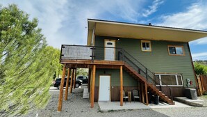 A two-story building with a balcony, a staircase, and a door. - Beautiful Apartment With Great Views In The Colorado Countryside. (Durango)
