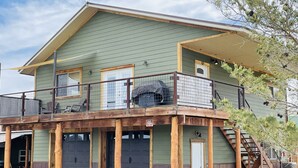 A two-story house with a balcony, a garage, and a chimney. - Beautiful Apartment With Great Views In The Colorado Countryside. (Durango)