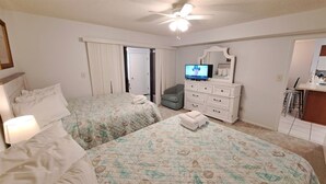 A hotel room with two beds, a TV, a dresser, and a chair. - Relaxation #201 Free Beach Service Included Chateau La Mer II 1st Fl (Destin)