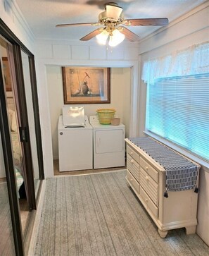 A laundry room with a ceiling fan, a washing machine, a dryer, and a window with blinds. - Relaxation #201 Free Beach Service Included Chateau La Mer II 1st Fl (Destin)