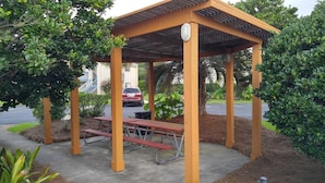 A covered picnic area with benches and a trash can. - Relaxation #201 Free Beach Service Included Chateau La Mer II 1st Fl (Destin)