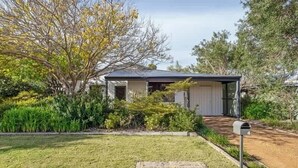 A residential house with a garage, a front yard with a lawn, and a mailbox. - Cormorant Cottage—Garden Beach Abode w/ Game Room (Dunsborough)