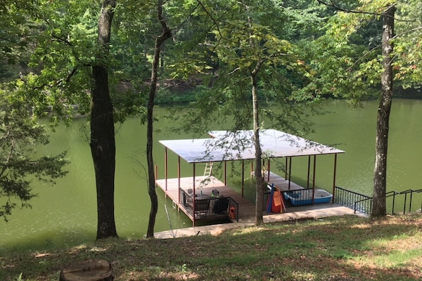 Boathouse protected from the wind and waves of the big river.