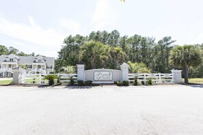 Players Village offers an entrance with a charming picket fence and a welcoming community sign.