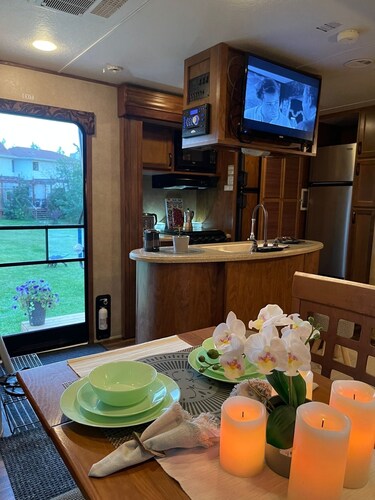 Flex RV Travel trailer parked on a beautiful 4 acre lot, overseeing forest land.