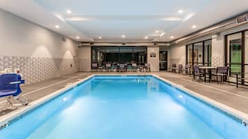 Relax by the pool surrounded by a geometric patterned floor and comfortable seating.