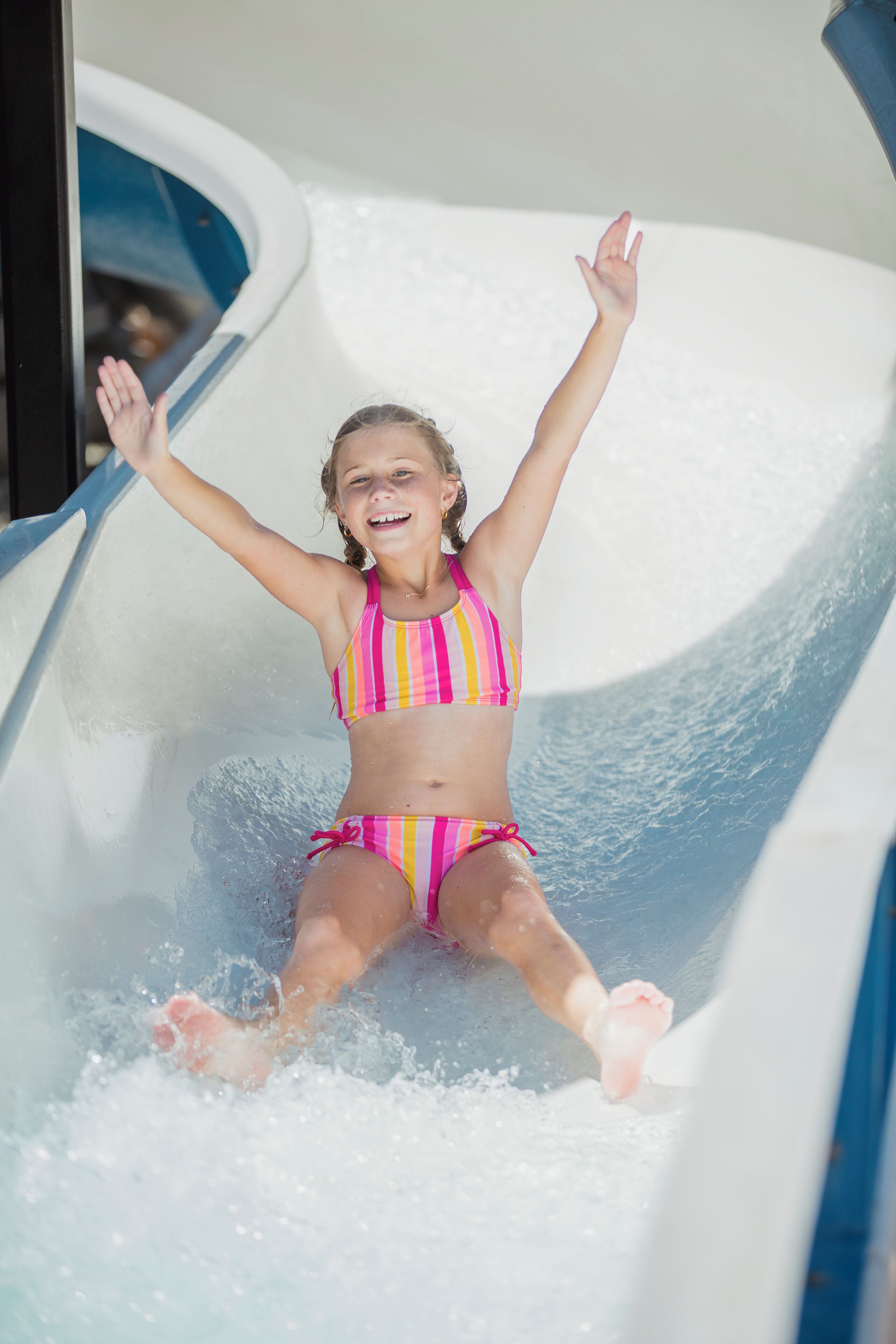 A child sliding down a water slide.