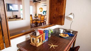 A wooden desk with a starfish, a lamp, books, and a cup. - Walk to malecón, private Pool and Garden (Zona Central)