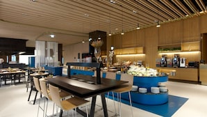 A modern restaurant with a central island, blue counter, and multiple seating areas. - The Place Taipei (Taipei)