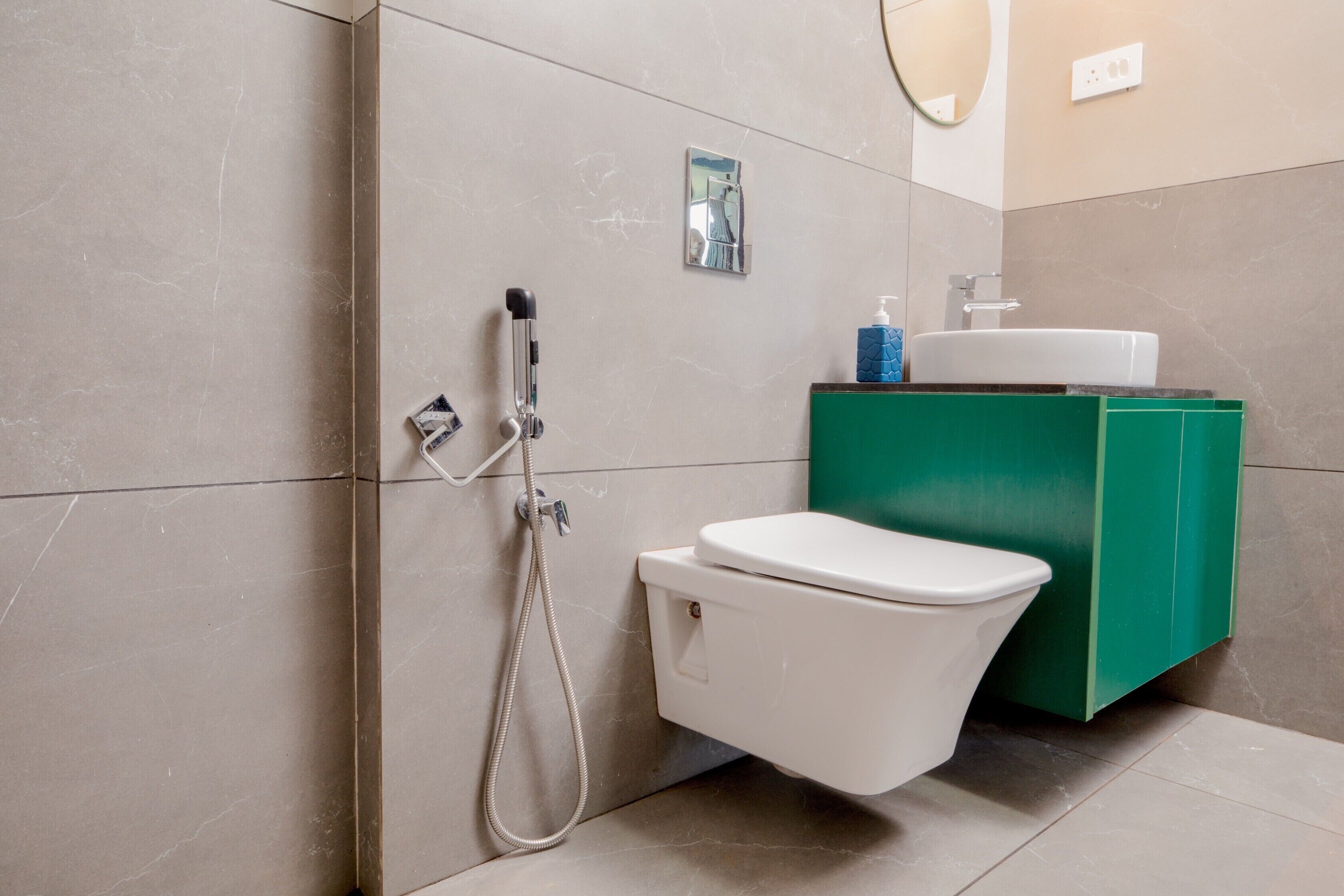 A modern bathroom with a toilet, a shower, and a sink.