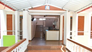 A staircase leading to a reception area with a tiled floor and a ceiling fan. - River Palace (Wai)