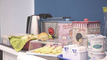 A kitchen counter with food items, a toaster, and a coffee maker.
