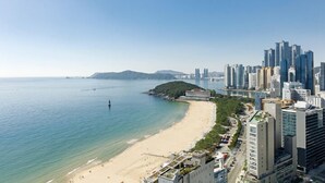 Un paisaje urbano costero con una playa y edificios altos.