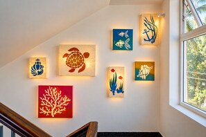 A staircase with a handrail and a wall decorated with various sea-themed artworks. - Villa Calangute Phase 17- 12BR + Private Pool + Jacuzzi + Party Room + Games (Calangute)