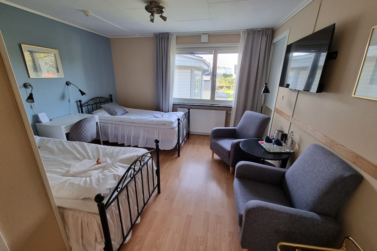 basic twin room | hypo-allergenic bedding, desk, laptop workspace, blackout curtains