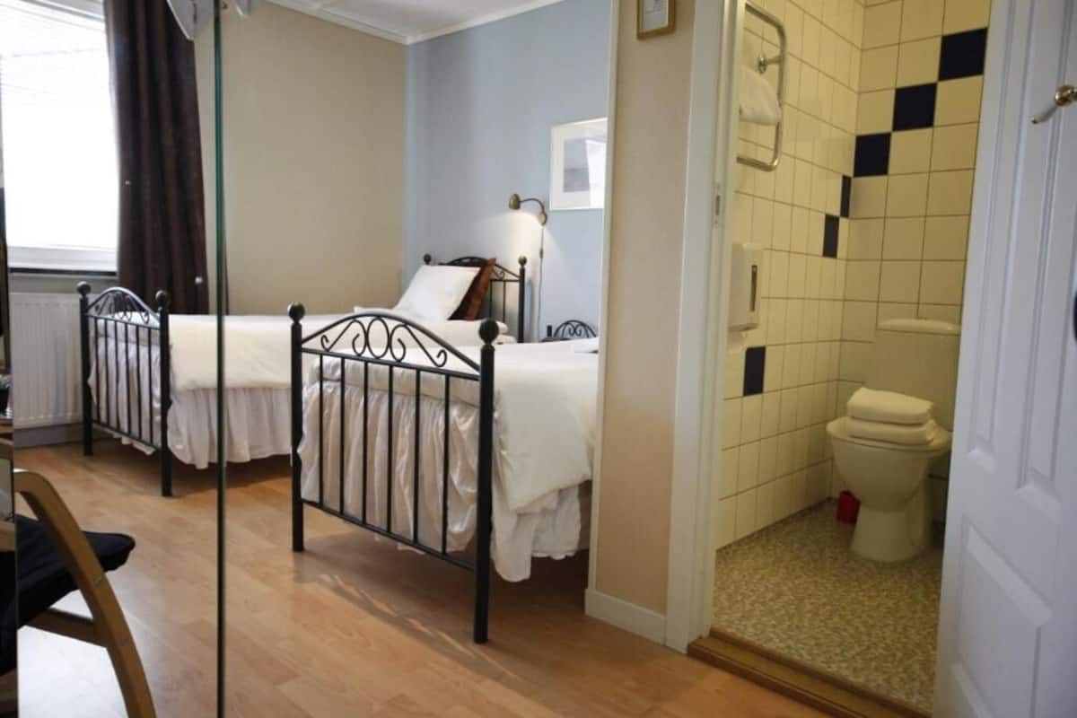 hypo-allergenic bedding, desk, laptop workspace, blackout curtains