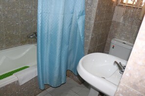 Combined shower/bathtub, deep-soaking bathtub, towels