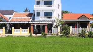 A two-story building with a sign reading "Hoang Y Homestay". - Hoang Y Homestay (Da Nang)