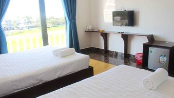 Deluxe Triple Room, Garden View | Minibar, desk, soundproofing, iron/ironing board