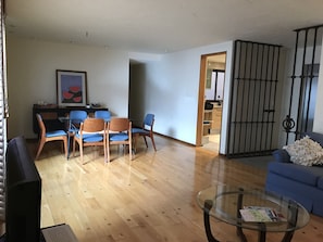 Relax in this stylish living space with a dining area, comfortable sofa, and flat-screen TV.