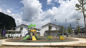 A playground with slides and climbing structures, surrounded by buildings and a clear sky. - De Little Cabin near Sunway Lost World of Tambun Ipoh, Perak Malaysia. (Ipoh)