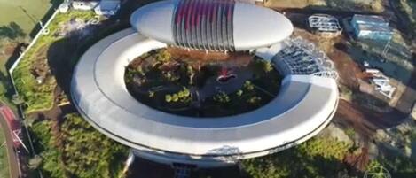 A circular building with a central open area and a tiered roof structure.