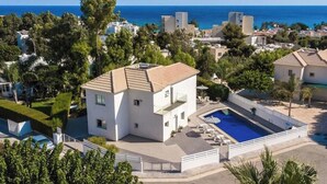 A modern two-story house with a swimming pool, surrounded by greenery and a view of the sea. - Villa Hibiscus is a unique and spectacular four bedroom villa in an residential gated cul de sac (Protaras)