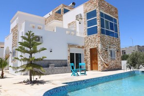 Enjoy a refreshing dip in the pool surrounded by a spacious patio.