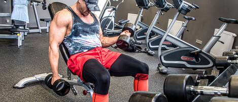A gym with various exercise equipment, including dumbbells and treadmills.